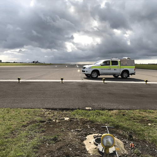 authorised person AGL in aiport vehicle inspecting the runway